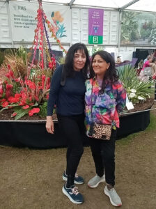 p17 LEAD Inset 1 Chila at Chelsea. Chila Burman with actress Mamta Kaash with flowers from Barbados 26 May 2024
