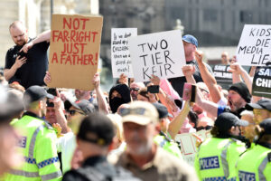 LEAD Turn Splash INSET Placard two tier policing GettyImages 2164616835